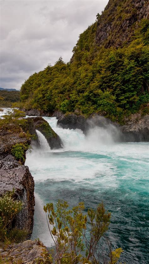 River Petrohué Waterfalls with rock formations and Osorno Volcano in ...