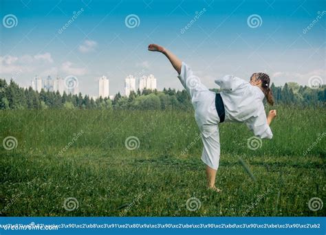 Teenage Girl Training Karate Kata Outdoors, Performs the Uro Mawashi ...