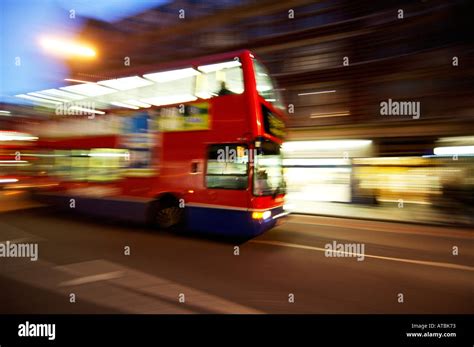 london double decker bus at night with motion blur to show movement ...