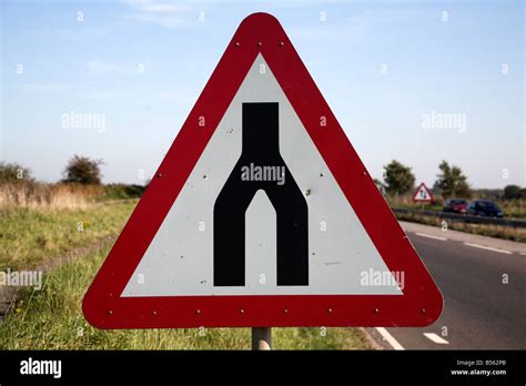 End of dual carriageway red triangular road sign Stock Photo - Alamy