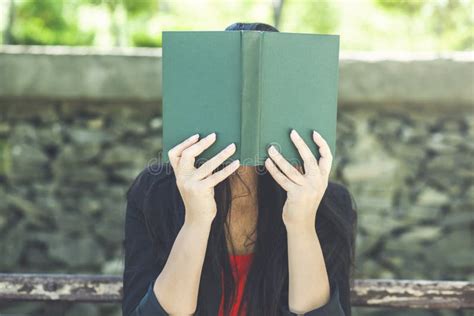 Girl with Hair Covers Her Face with a Book Stock Image - Image of young ...