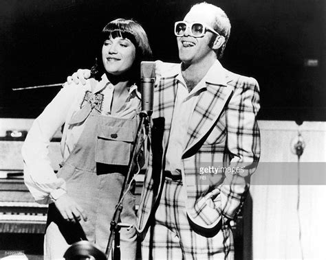 Photo of Kiki DEE and Elton JOHN; Elton John performing on stage with ...