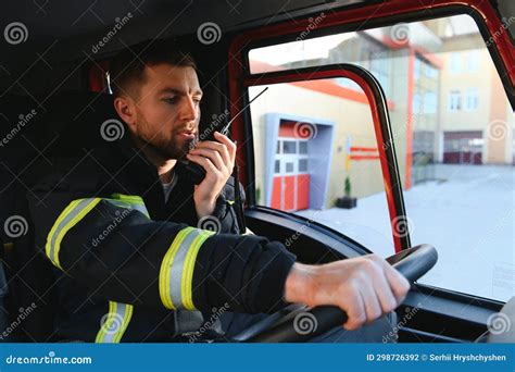 Firefighter Using Radio Set while Driving Fire Truck Stock Photo ...