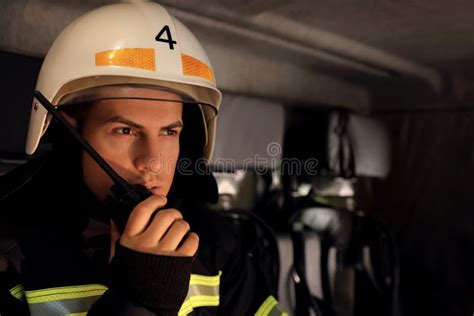 Firefighter Using Portable Radio Set in Fire Truck Stock Image - Image ...