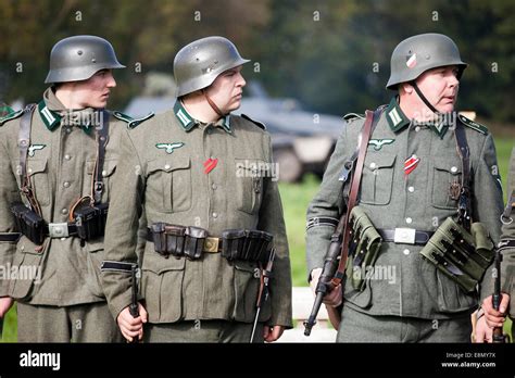 Three uniformed German soldier soldiers, ww2 military reenactor ...