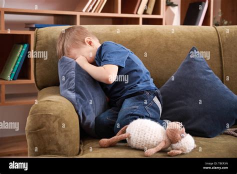 Sad little boy crying at home Stock Photo - Alamy