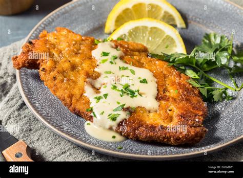 Homemade German Chicken Schnitzel with Lemon and Sauce Stock Photo - Alamy