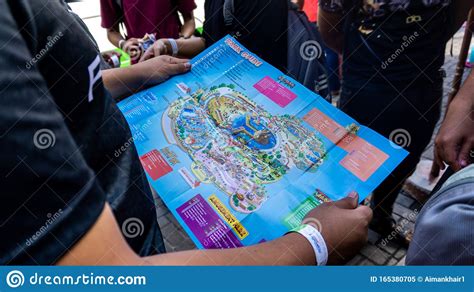 A Group Of Tourist Looking At The Park Guide Map Of Sunway Lagoon Theme ...