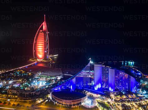 Aerial view of the luxurious Burj Al Arab Hotel by night in Dubai bay ...