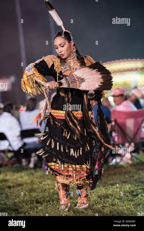 Native American woman performing jingle dress dance during Sac & Fox ...