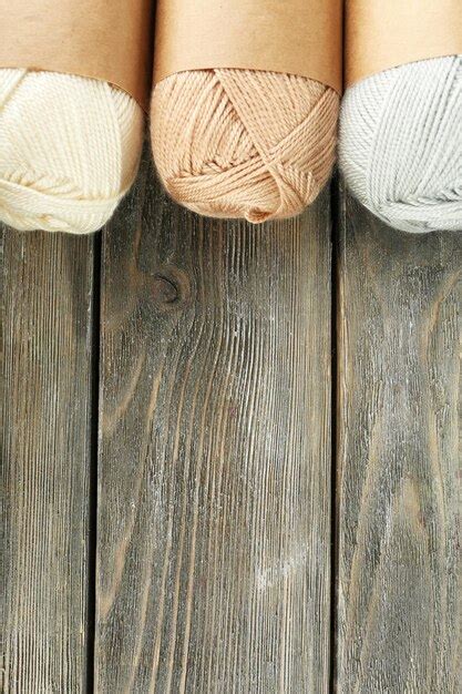 Premium Photo | Knitting yarn on wooden background