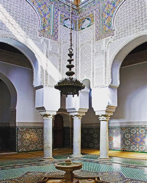 the interior of an ornate building with white and blue tiles