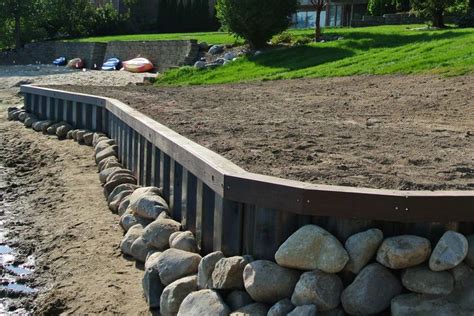 Contractor building a steel seawall bulkhead for lake property ...