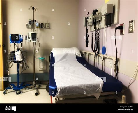 Emergency room hospital bed surrounded by medical equipment Stock Photo ...