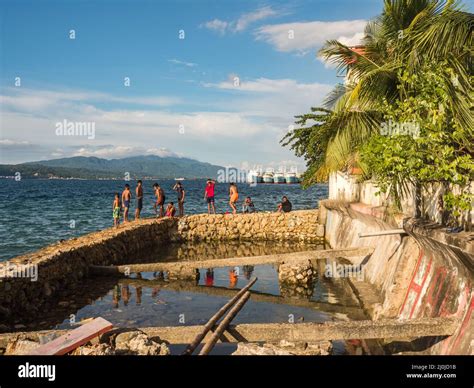 Ambon, Indonesia - February 2018: Many children play and swim in the ...