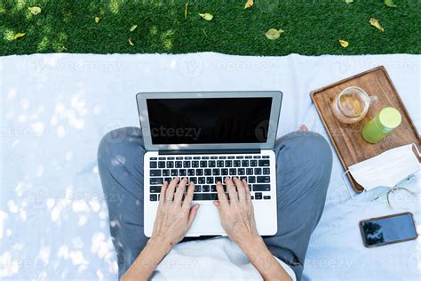 Person working on laptop outside 2727044 Stock Photo at Vecteezy