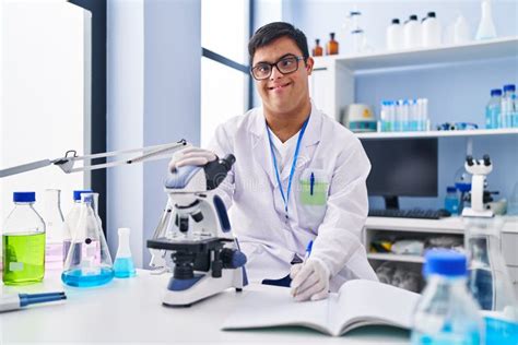 Down Syndrome Man Wearing Scientist Uniform Using Microscope Writing on ...