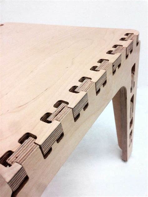 a close up of a wooden bench made out of plywood and wood with holes in it