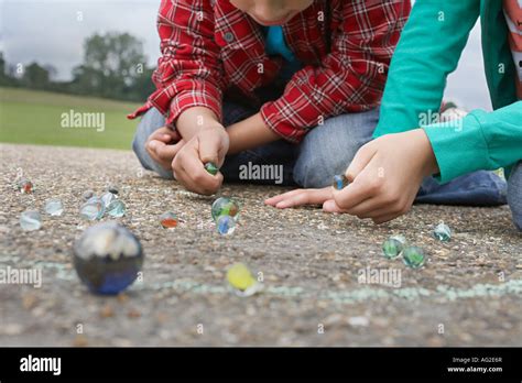 Children playing marbles hi-res stock photography and images - Alamy