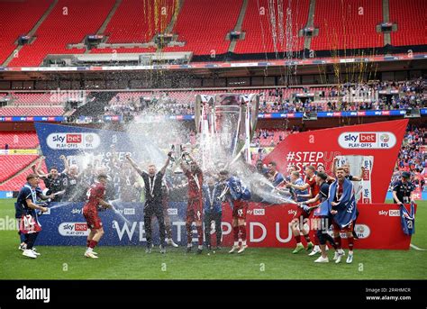 Carlisle United players celebrate with the trophy after being promoted ...