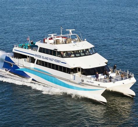 a large white and blue boat with people on it's back in the water