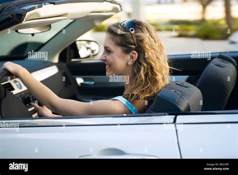 Young woman driving convertible Stock Photo - Alamy