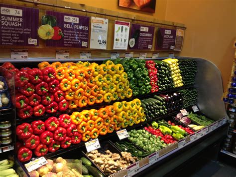 an assortment of fruits and vegetables on display in a grocery store