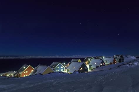 Premium Photo | Yellow blue red and green inuit houses covered in snow ...