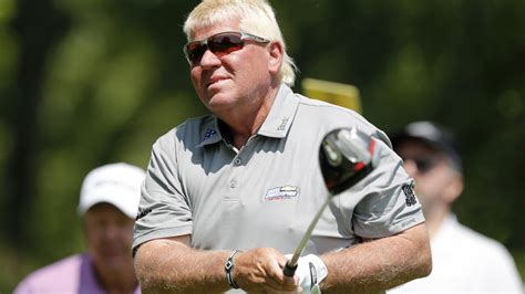 Golfer John Daly hits hole-in-one shoeless at golf tournament