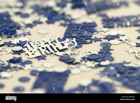 Blue happy birthday confetti pieces - macro photo Stock Photo - Alamy