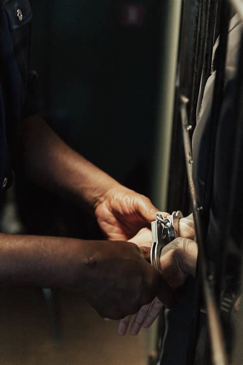 Handcuffs on hands of Prisoner in Jail · Free Stock Photo