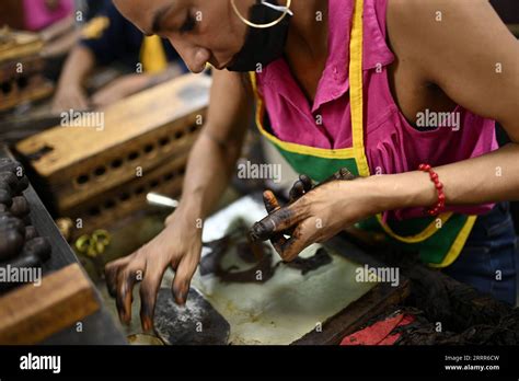 230509 -- DANLI, May 9, 2023 -- A worker makes a cigar at a factory in ...