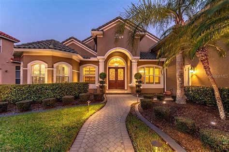 Spanish Style Home with Palm Trees and Lights in Orlando, FL