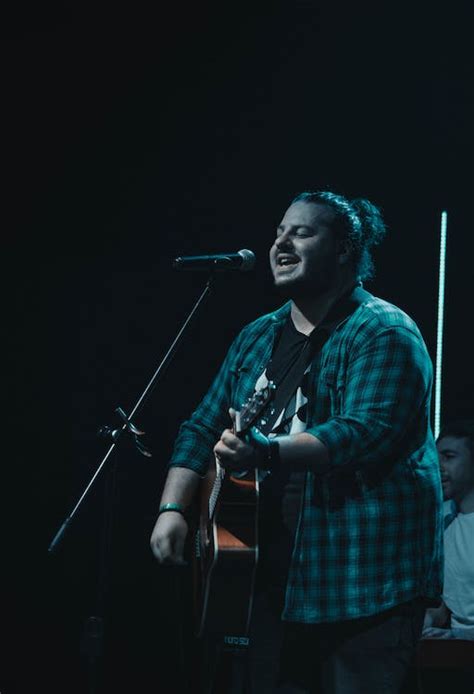 Man Playing Guitar While Singing · Free Stock Photo