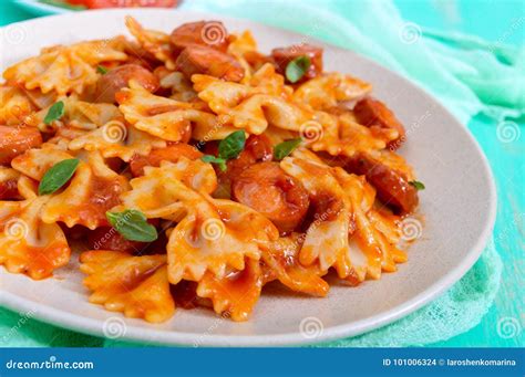 Farfalle Pasta with Chunks of Sausage in Tomato Sauce Stock Photo ...