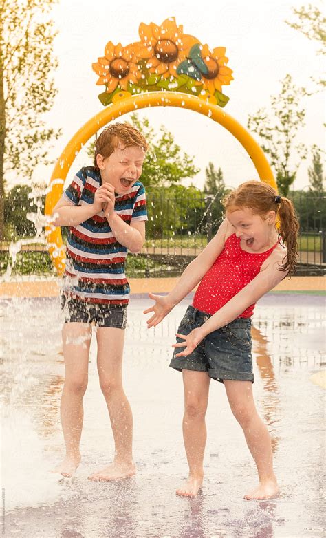 "Children Playing In A Water Play Area" by Stocksy Contributor "Craig ...