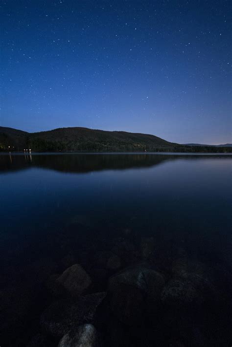 Lake View Under Clear Blue Night Sky during Night Time · Free Stock Photo