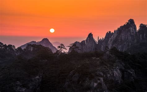 Sunrise at Huangshan - Huangshan is known for its sunrises, pine trees ...