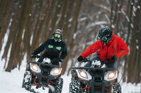 Conception of Extreme Sports. Two People are Riding ATV in the Winter ...