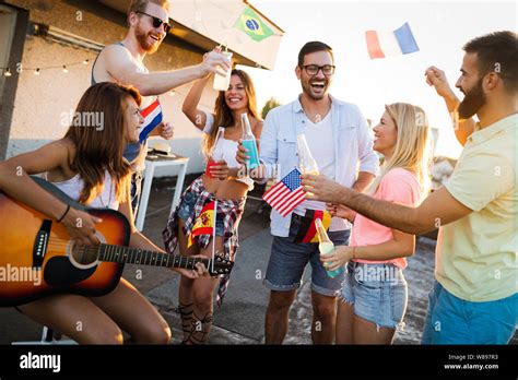 Group of happy friends having party on rooftop Stock Photo - Alamy