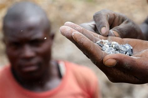 A miner holding coltan in a mine in Rukunda, Masisi territory, North ...