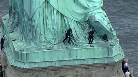 Liberty Island evacuated after woman scaled Statue of Liberty to ...