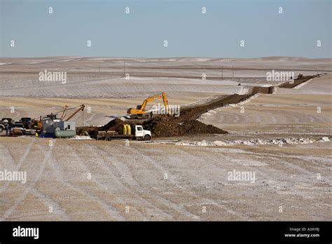 Track hoe digging pipeline ditch Stock Photo - Alamy