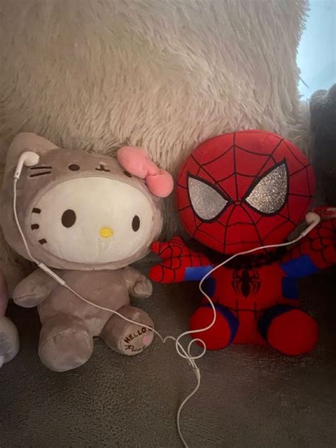 hello kitty and spiderman stuffed animals are on the floor next to ...