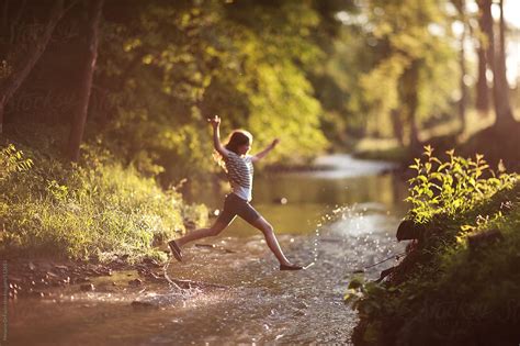 "Playing In The Creek" by Stocksy Contributor "Melanie DeFazio" - Stocksy