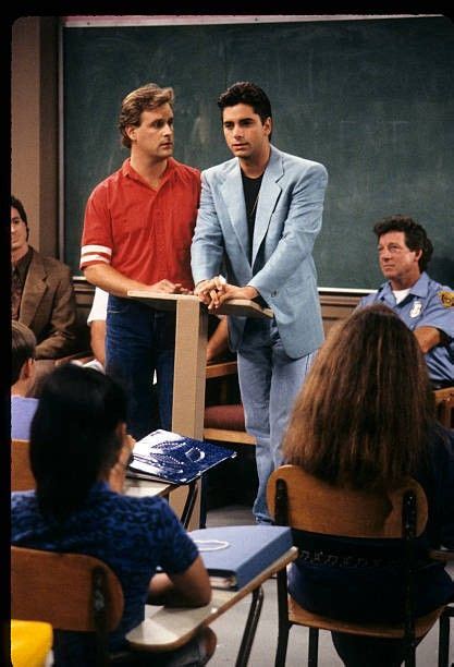 two men standing in front of a classroom full of students