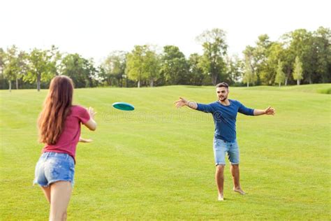 Couple in Love Playing Frisbee in the Park, the Concept of a Healthy ...