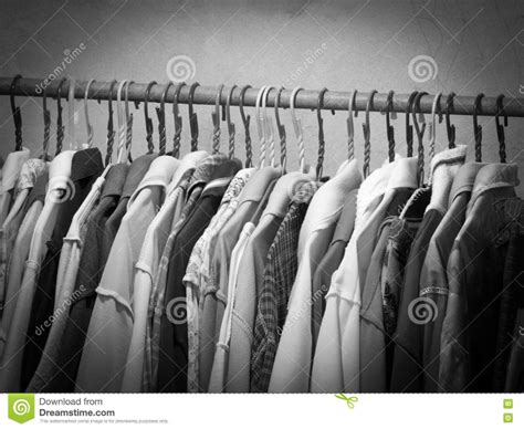 Black And White Image Of Clothes Hanging On Hanger Rack. Choice Of ...