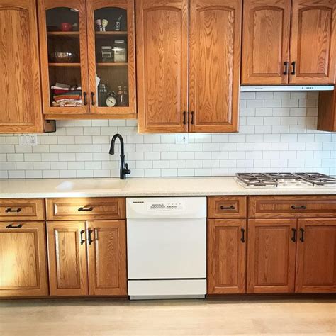 Oak cabinets with cream subway tiles & dark grout | Oak kitchen remodel ...