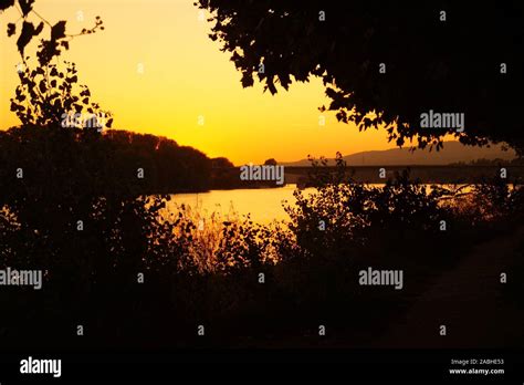 Beautiful sunset silhouette at a river Stock Photo - Alamy